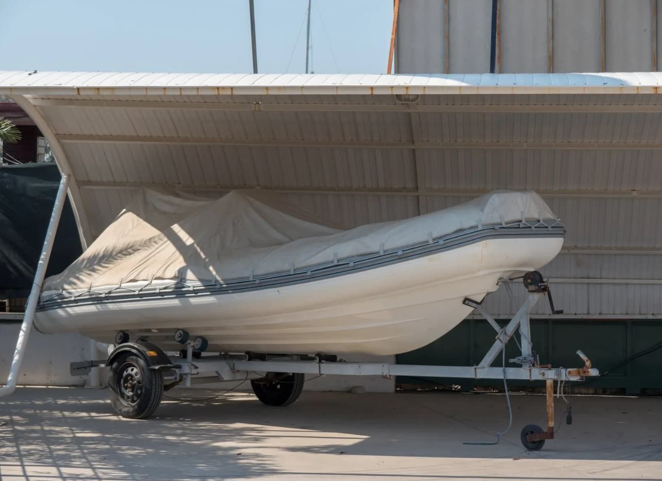 Boat Covered In White Tarp On A Trailer Under A White Awning — Cairns Budget Storage In Mount Sheridan, QLD