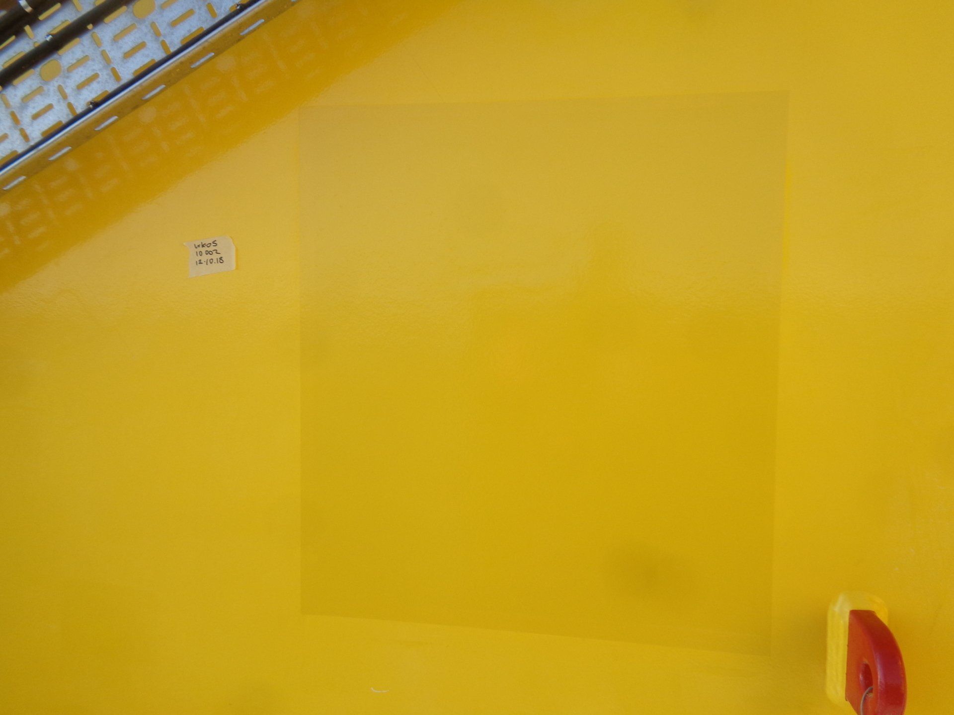A yellow surface of a previously painted patch on a offshore wind farm.