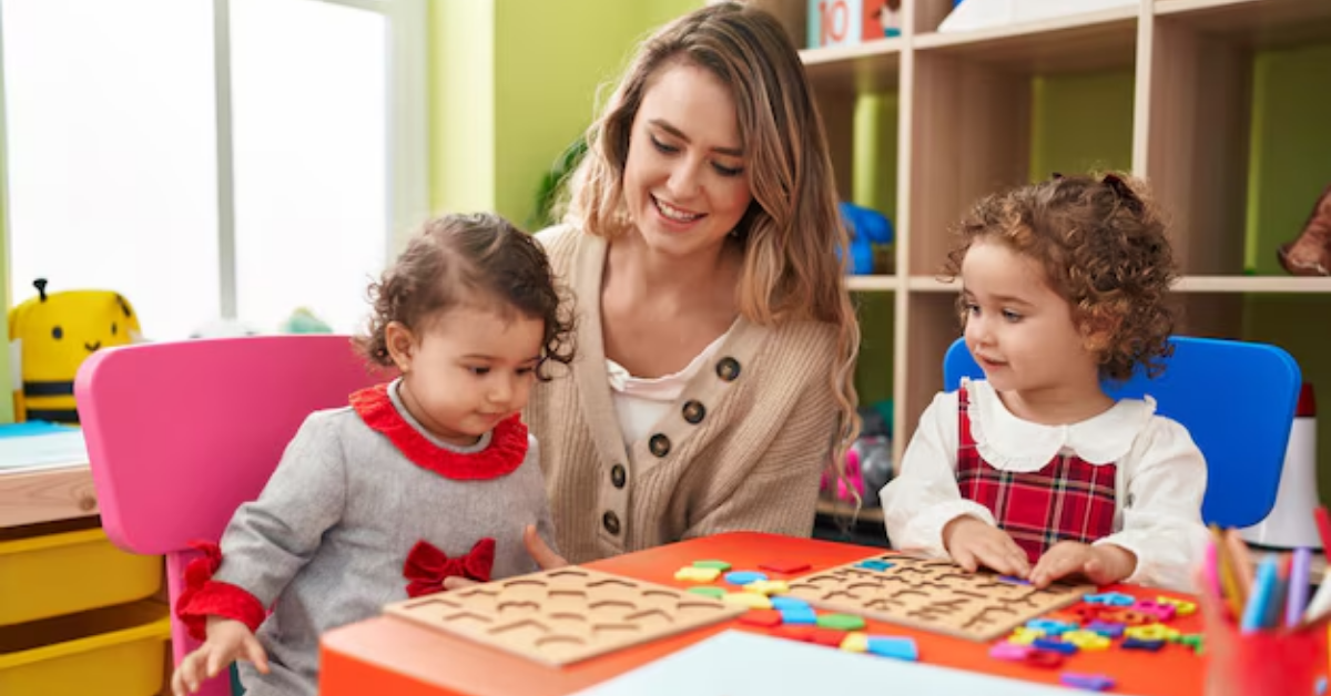 A woman is playing with two little girls at a table.