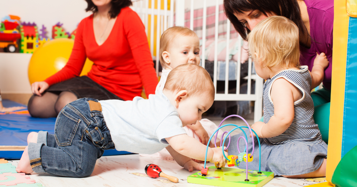 A group of children are playing with toys on the floor.