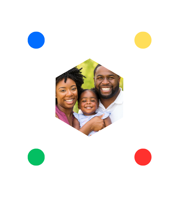 A family is posing for a picture in a hexagon with colorful circles around them.