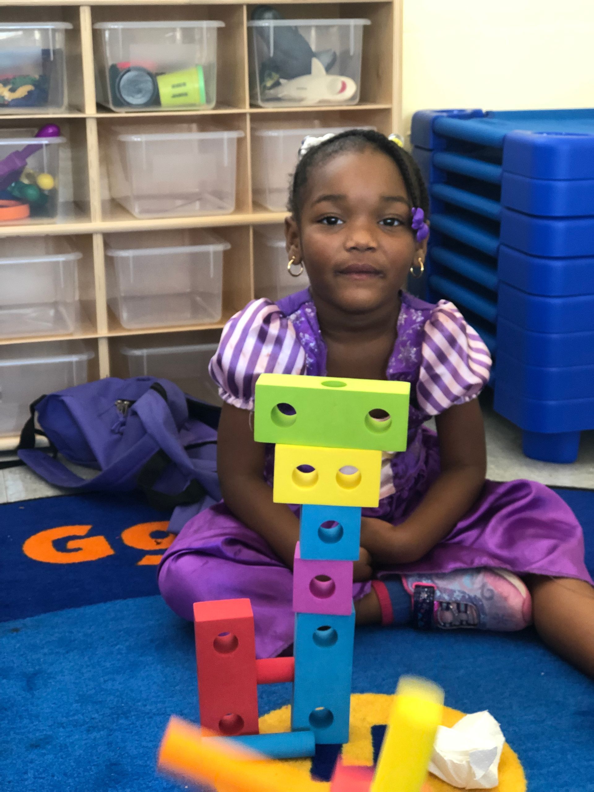 A boy wearing a shirt that says game on it