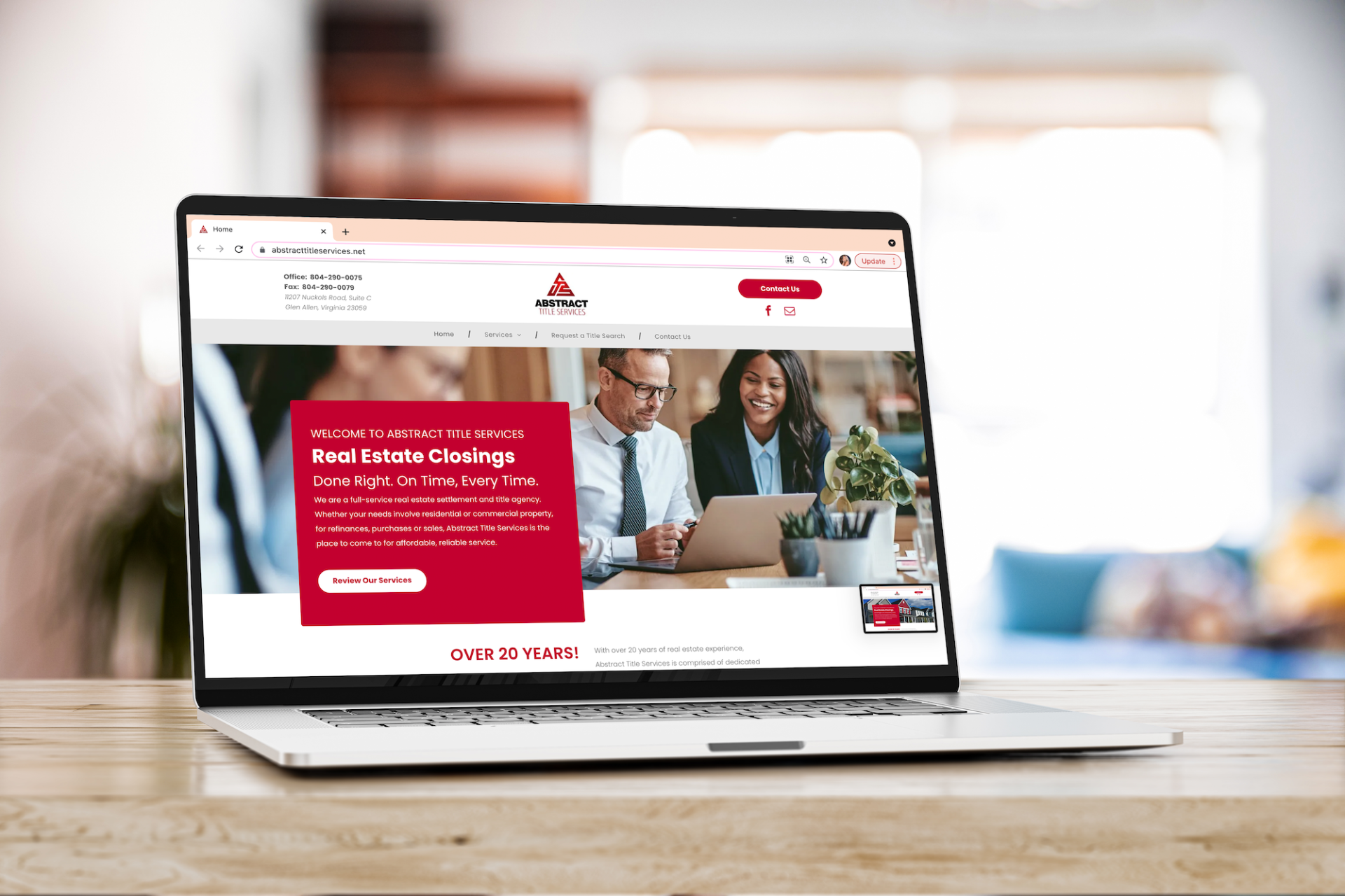 A laptop computer is sitting on a wooden table.