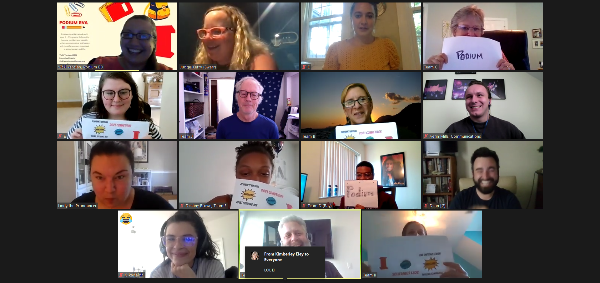 A group of people are holding up signs on a video call.