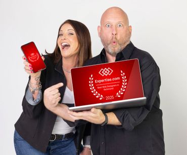 Woman points at a phone, man holds laptop. Both display 