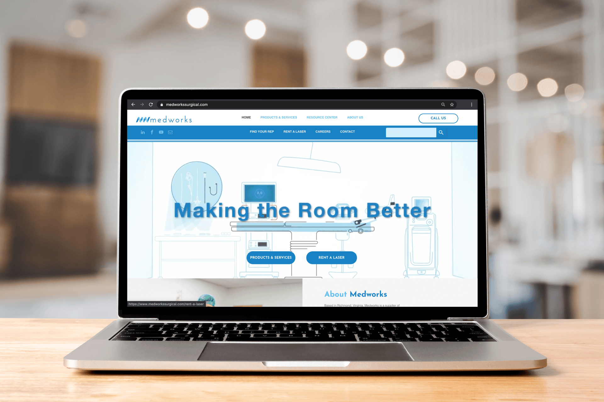 A laptop computer is sitting on a wooden table.