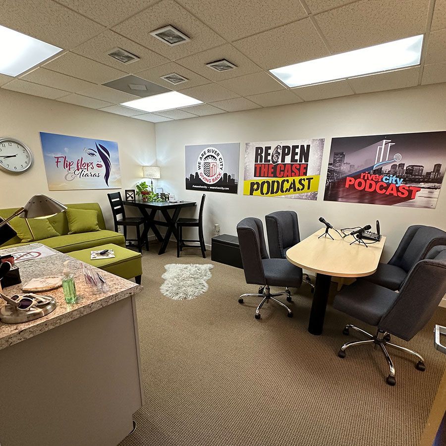 A room with a table and chairs and a sign that says podcast