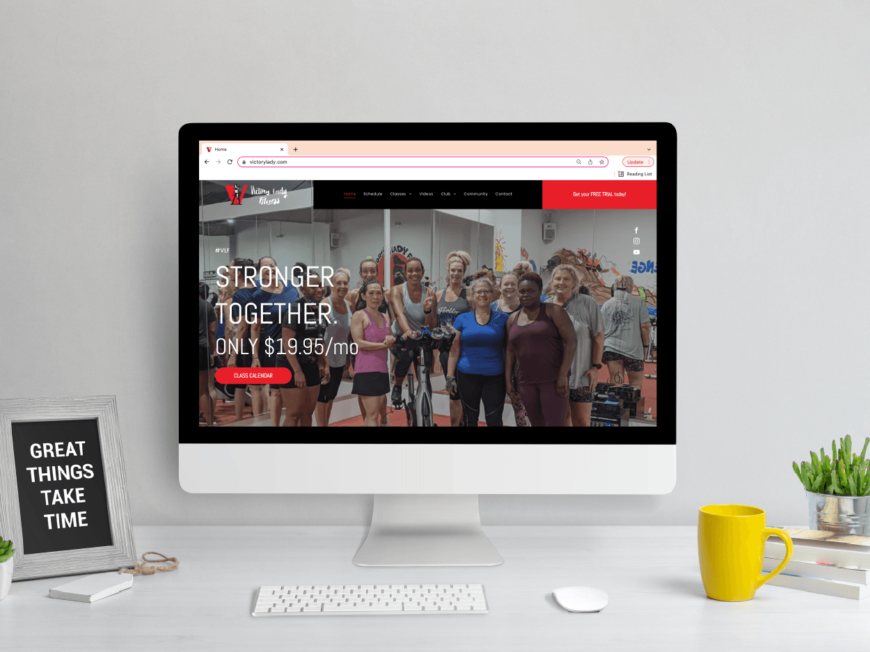 A computer monitor is sitting on a desk next to a cup of coffee.