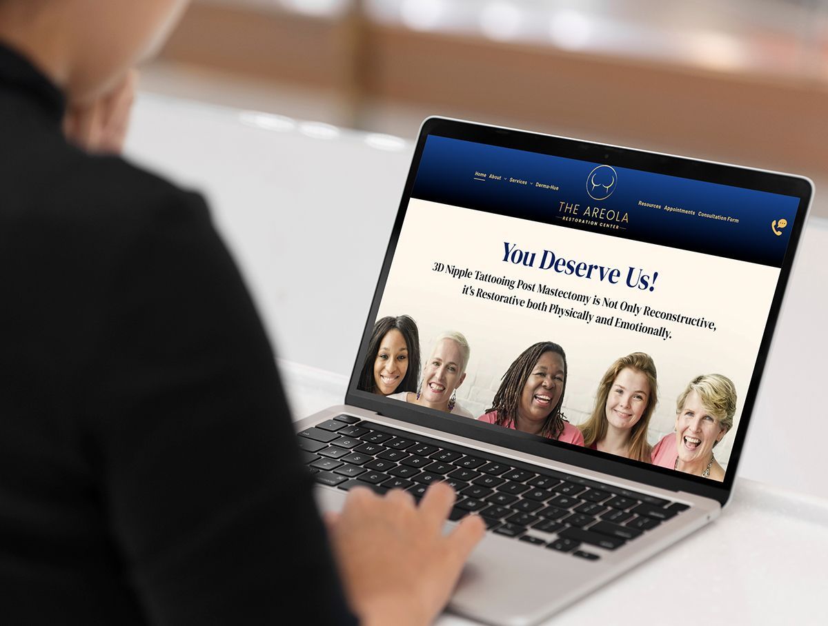 a woman is using a laptop computer with a website on the screen