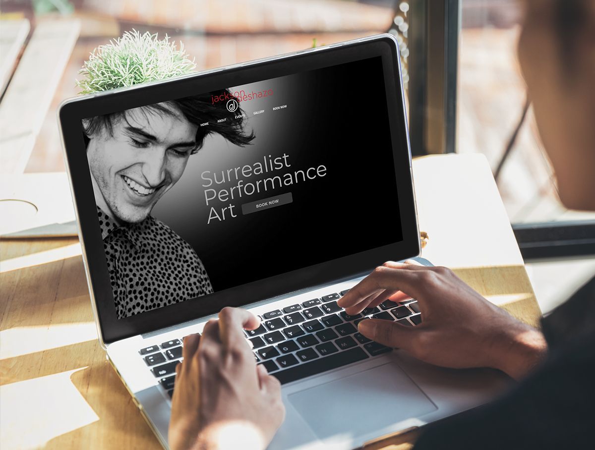 a person is using a laptop computer with a picture of a man on the screen