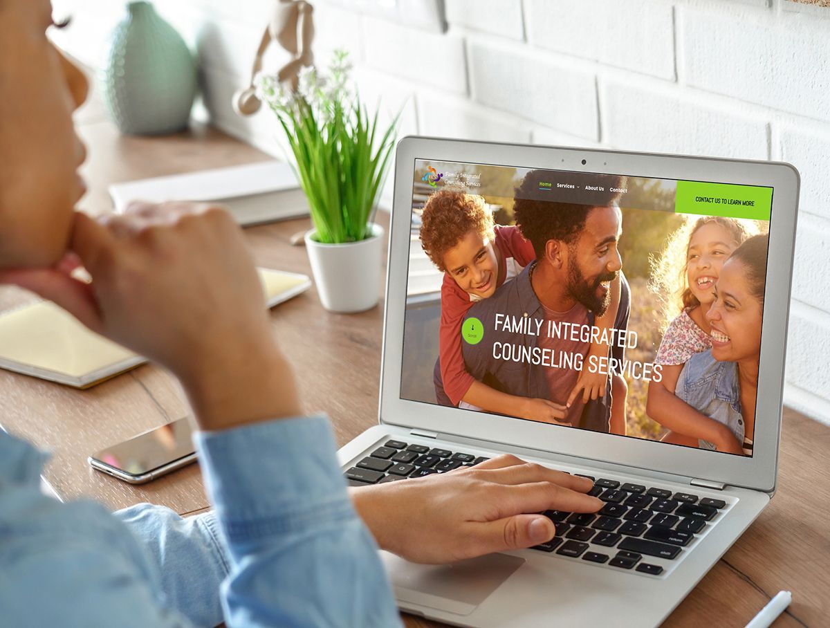 a person is using a laptop computer with a picture of a family on the screen