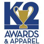 A logo for k2 awards and apparel with a trophy in the middle.
