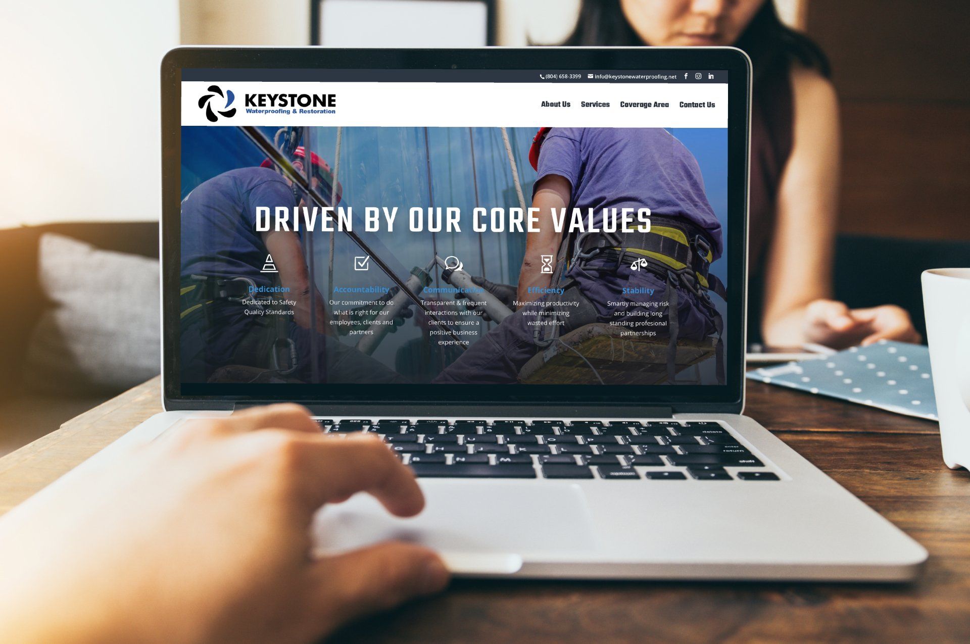 a person is using a laptop computer with the website driven by our core values on the screen