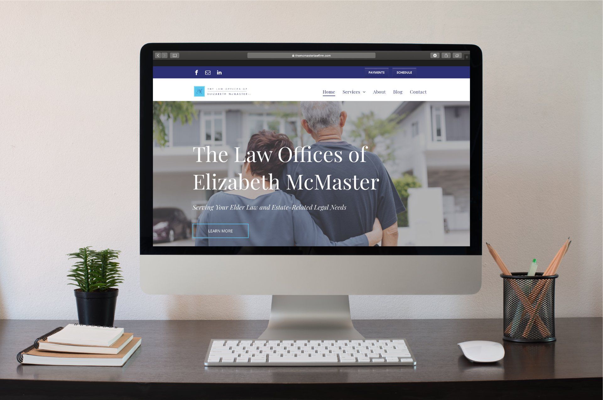 A computer is sitting on a desk with a website on the screen.