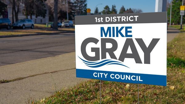 A sign that says mike gray city council on it