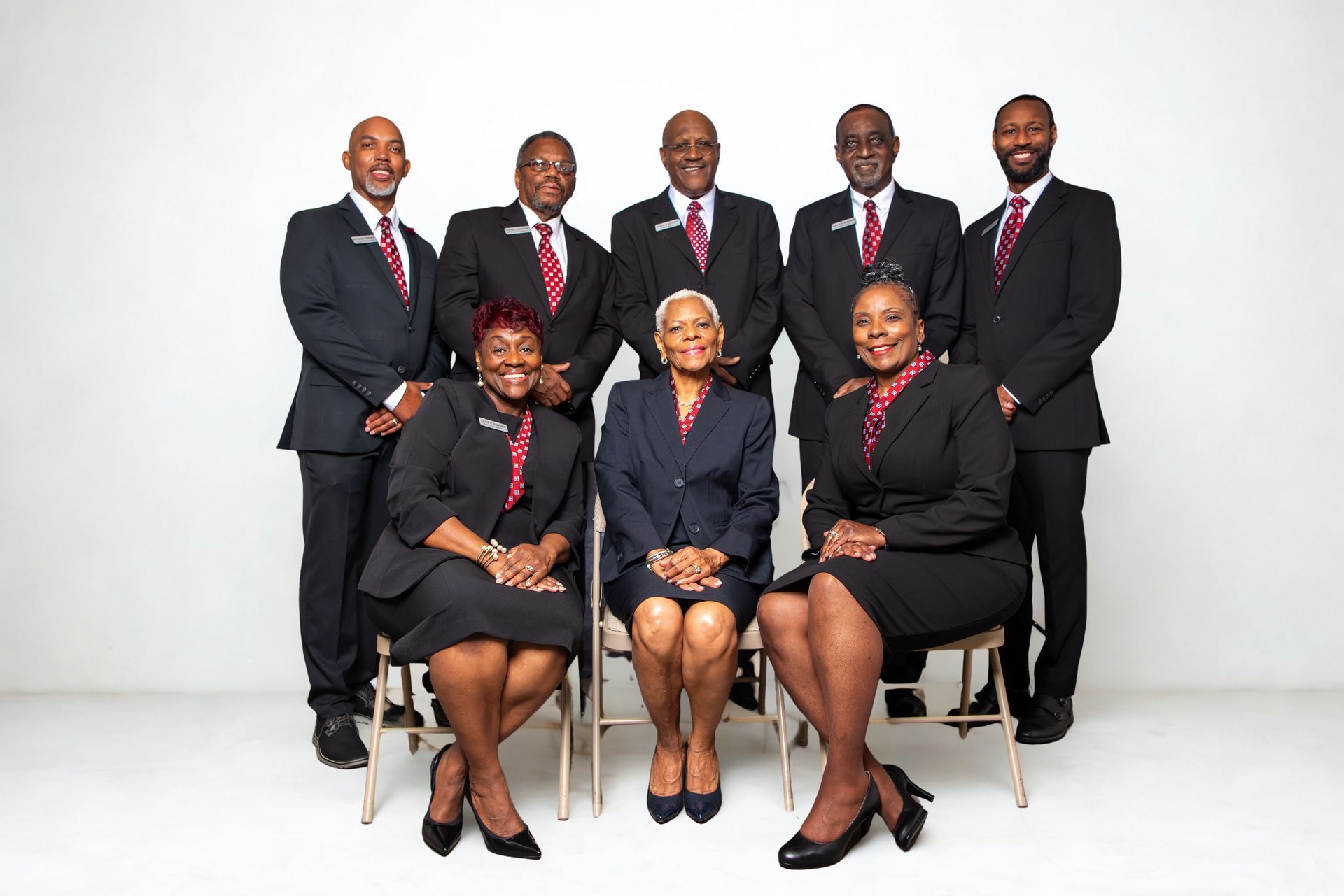The front door of a house with a porch and plants in front of it.