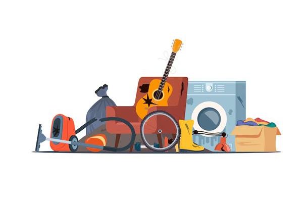 Pile of discarded items: chair, guitar, bicycle wheel, washing machine, boots, box of clothes, and other trash.