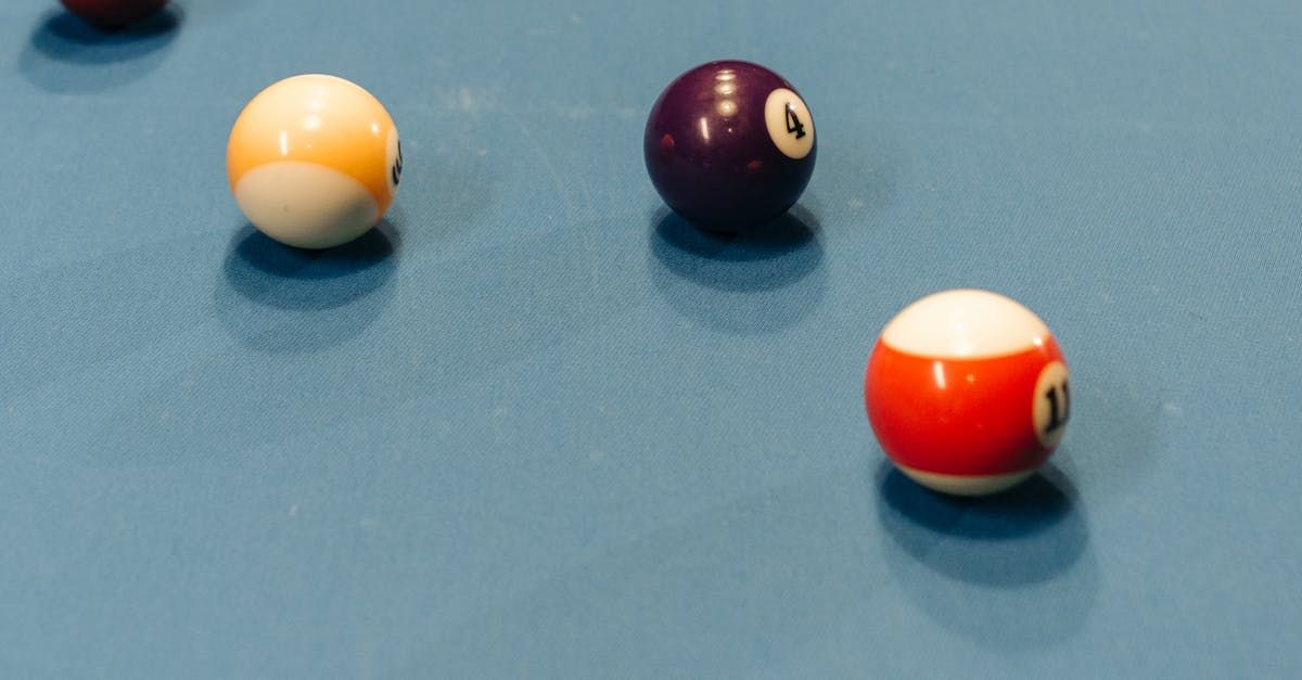 Pool table with three numbered billiard balls: 2, 8, and 10, in view. Blue felt.