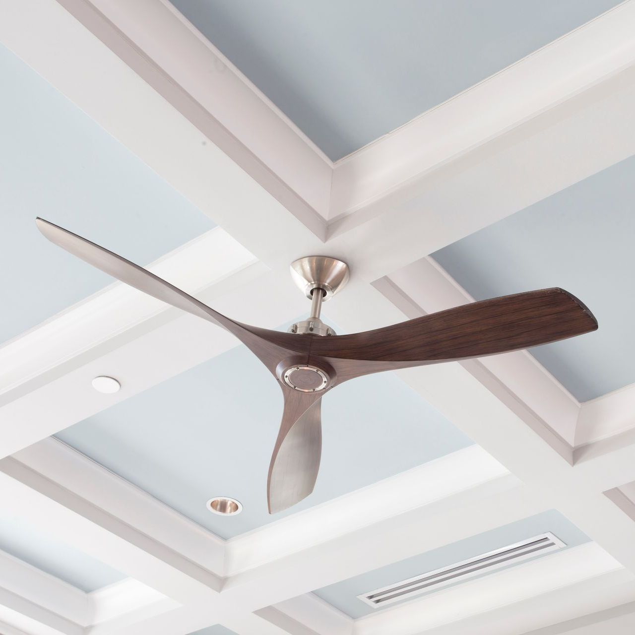 A ceiling fan is hanging from the ceiling of a room