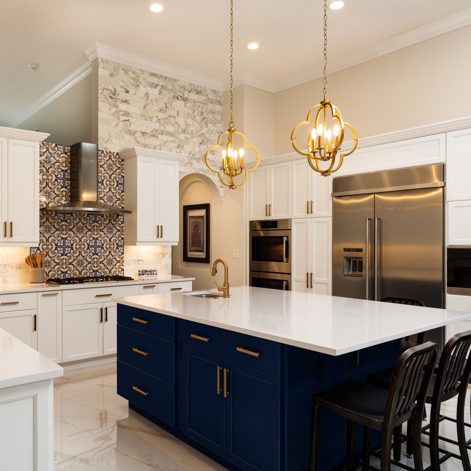 A kitchen with blue cabinets and white counter tops