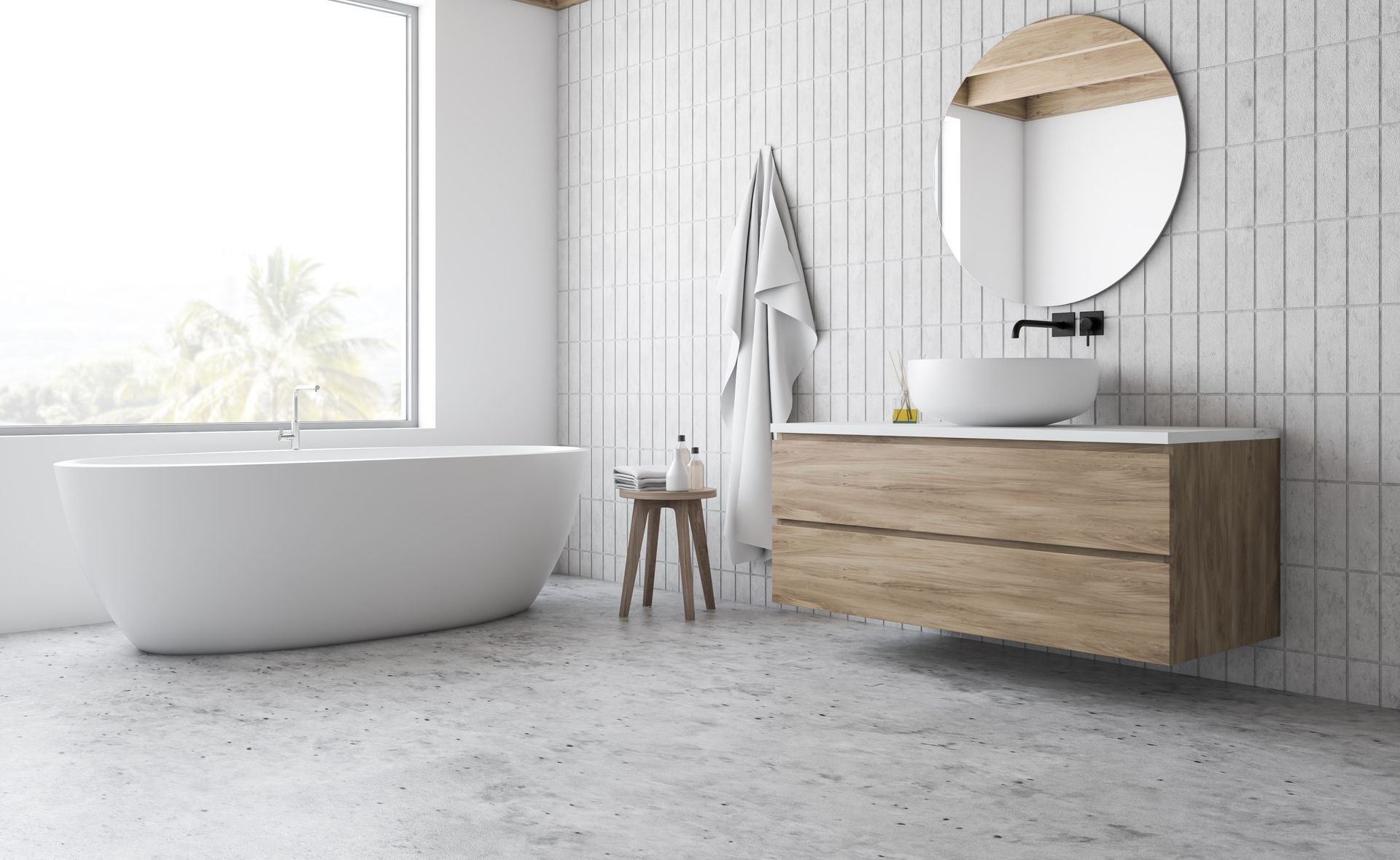 A bathroom with a bathtub , sink , mirror and window.