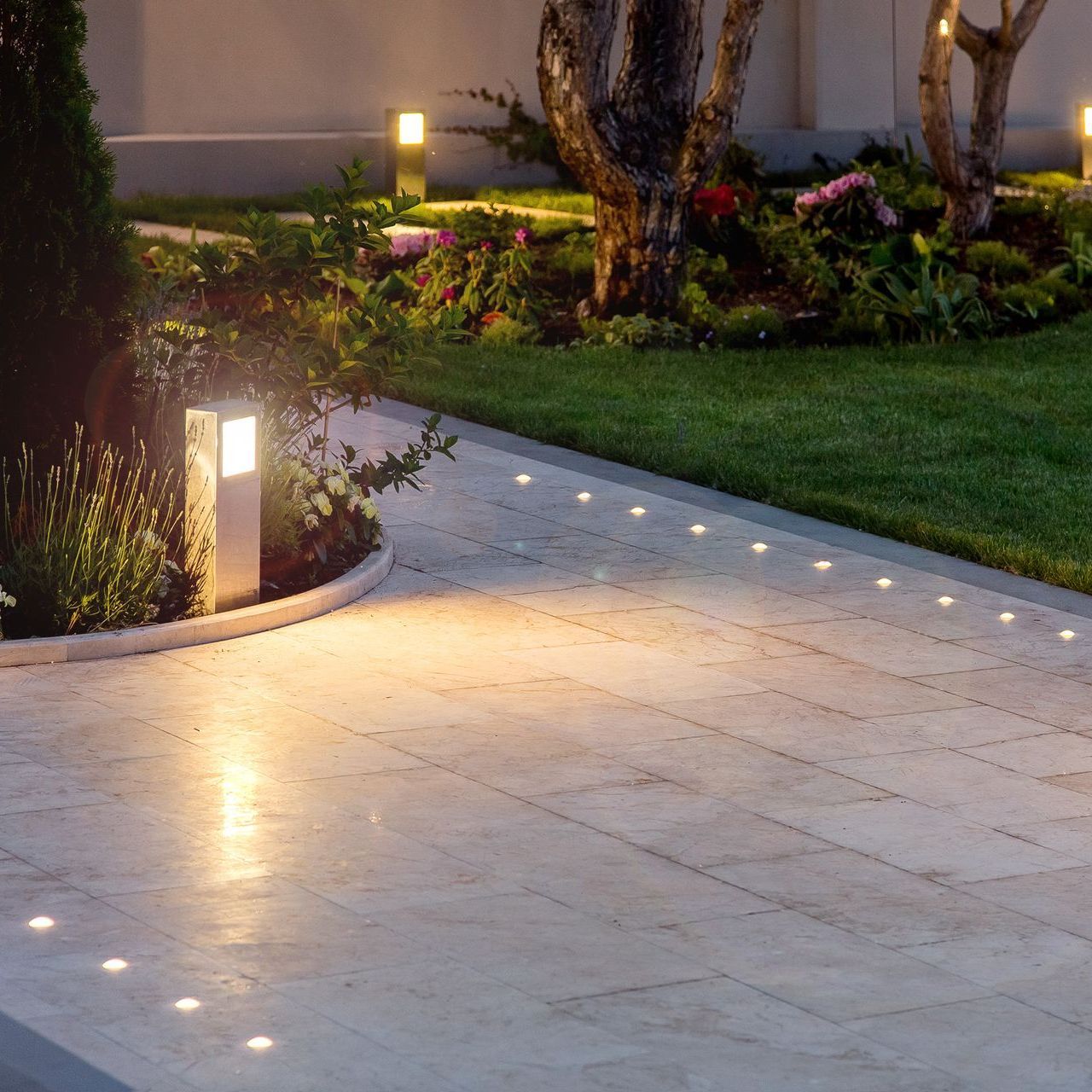 A brick walkway with a few lights on it