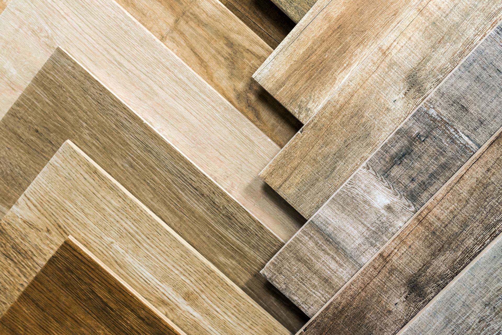 A close up of a stack of different types of wooden flooring.