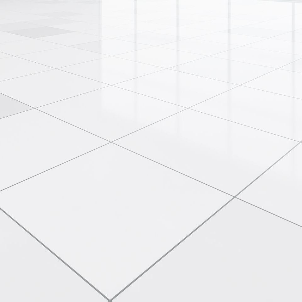 A white tiled floor in an empty room with a reflection of a window.