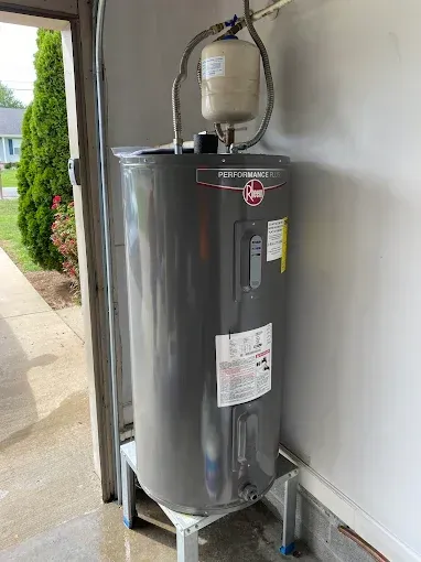 Gray water heater with expansion tank in a garage.