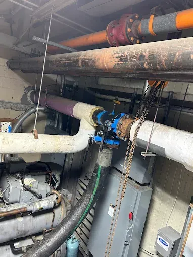Solar panels installed on a red-tiled roof against a partly cloudy sky.