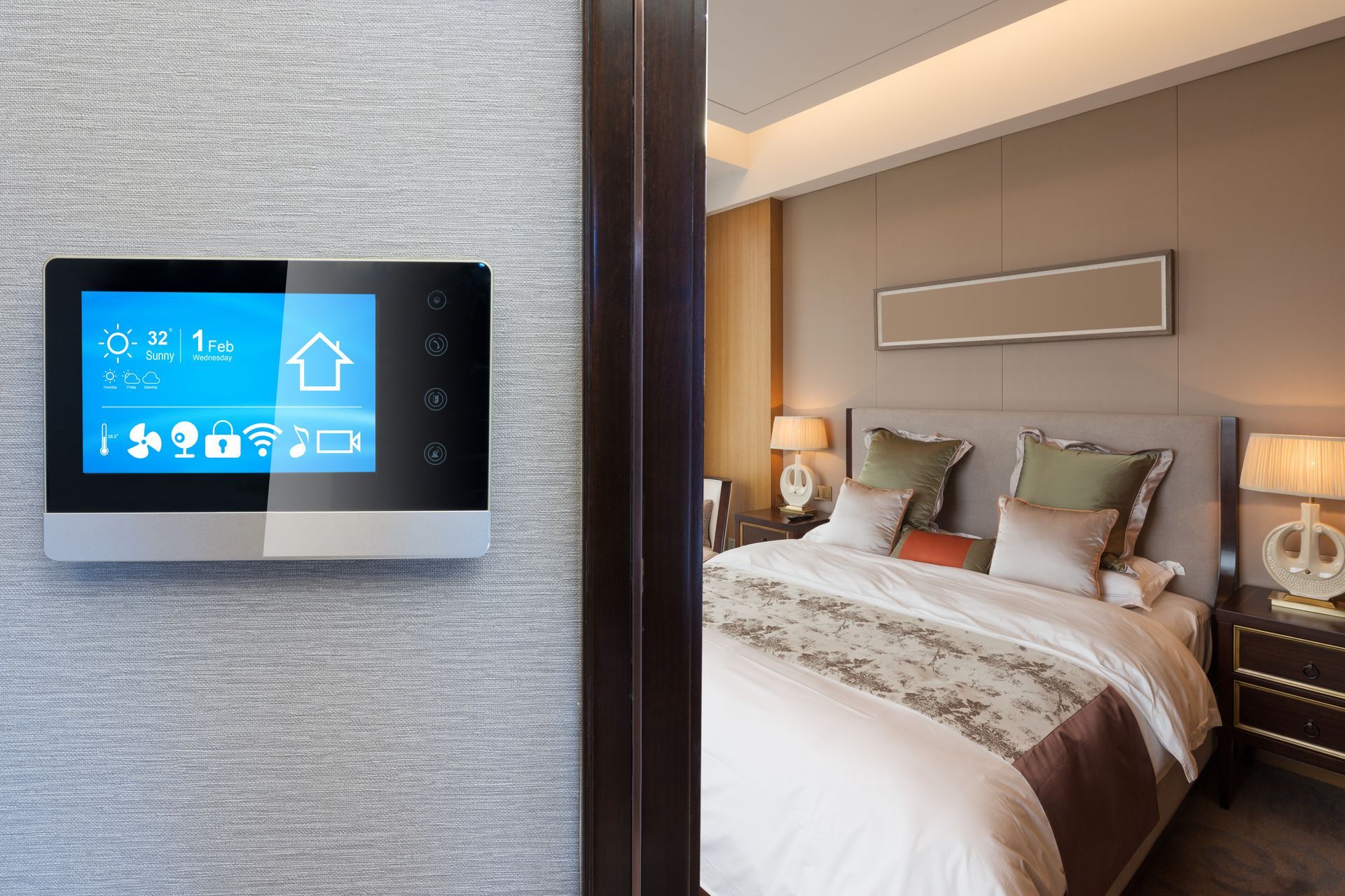 Smart home control panel on wall, showing icons; bedroom with bed visible through doorway.