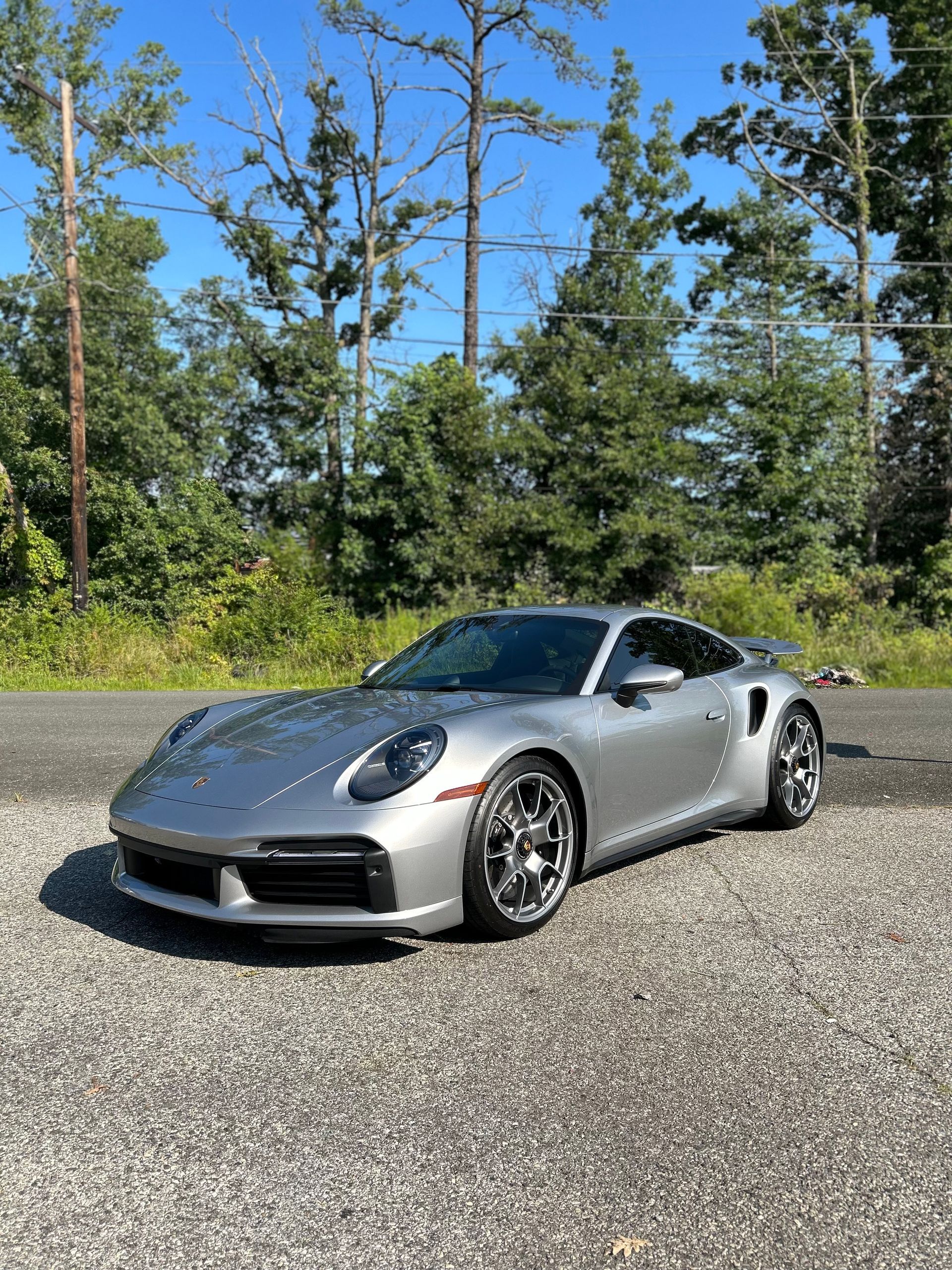 A man is working on a red car in a garage.