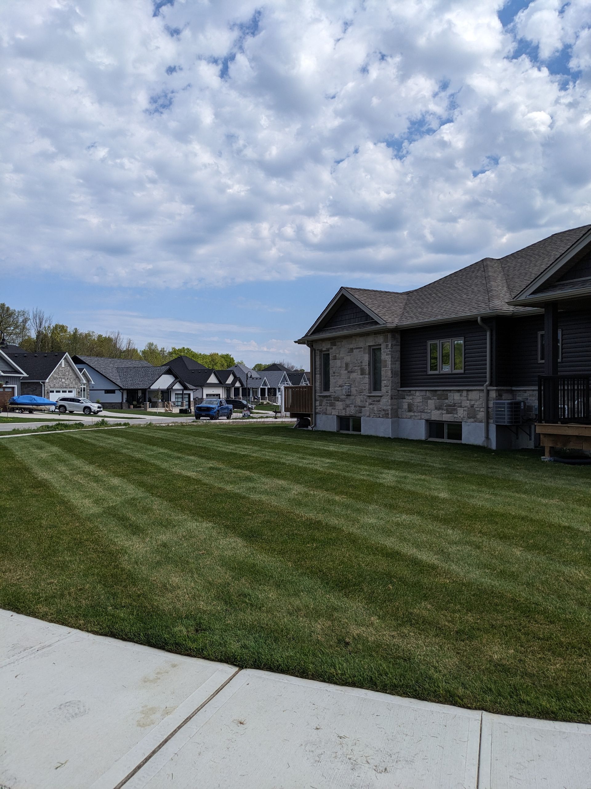 A house with a lush green lawn in front of it