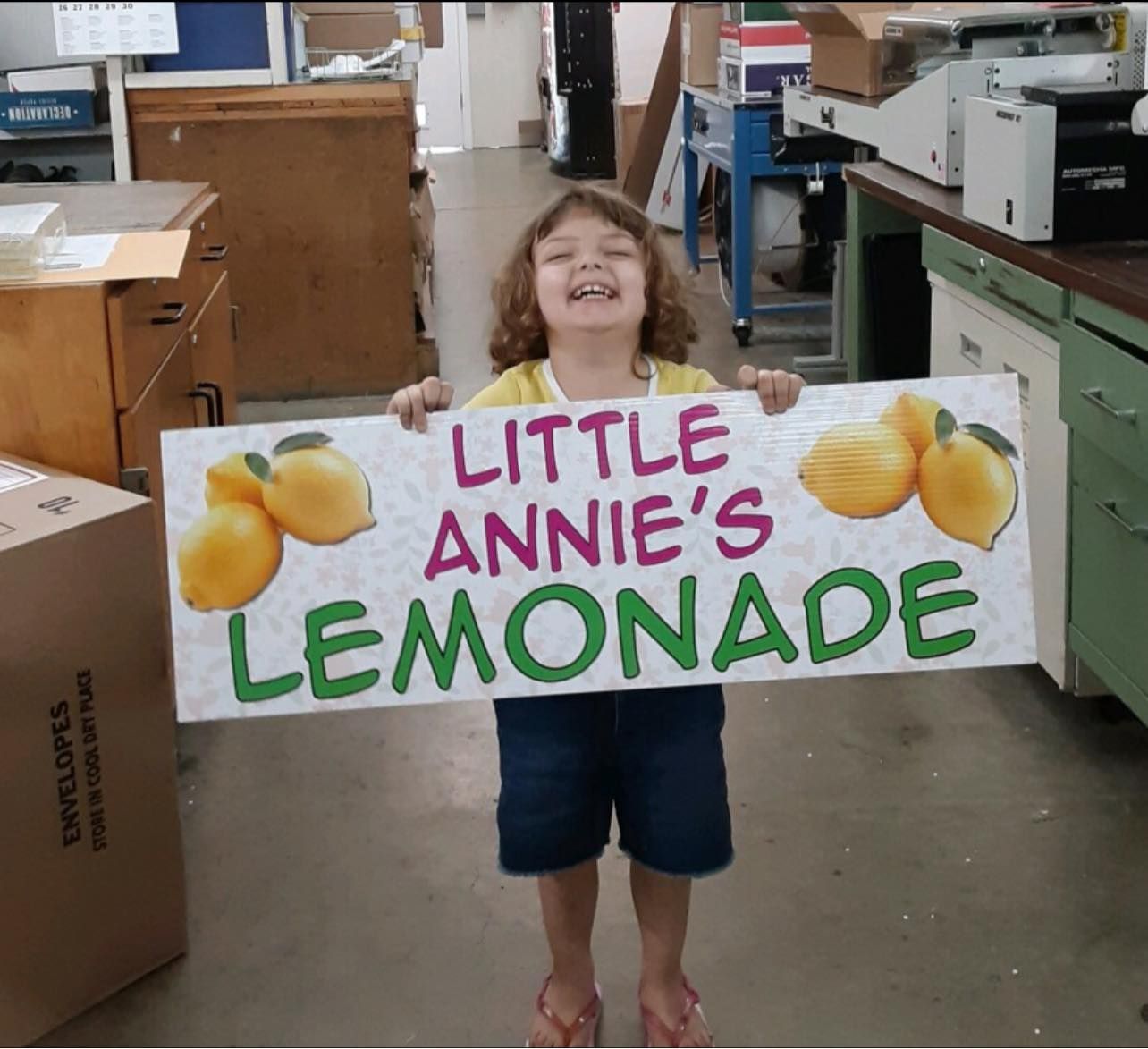 A little girl is holding a sign
