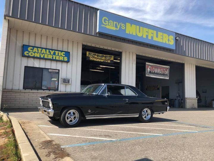 Gary's Muffler Shop exterior  with black classic car