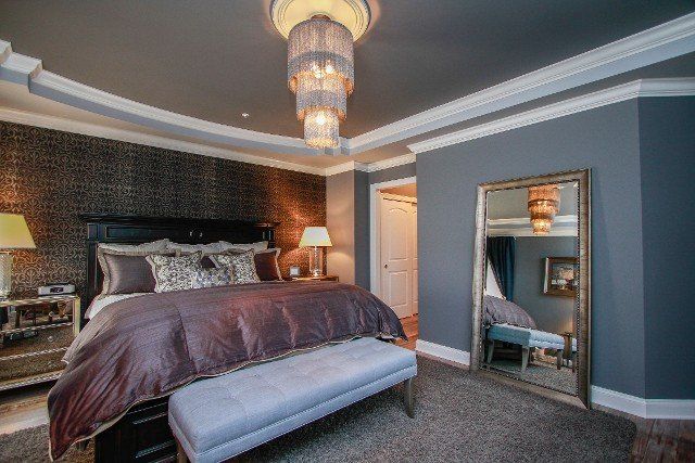 Bedroom with elegant chandelier - Painting contractors in Jarrettsville, MD