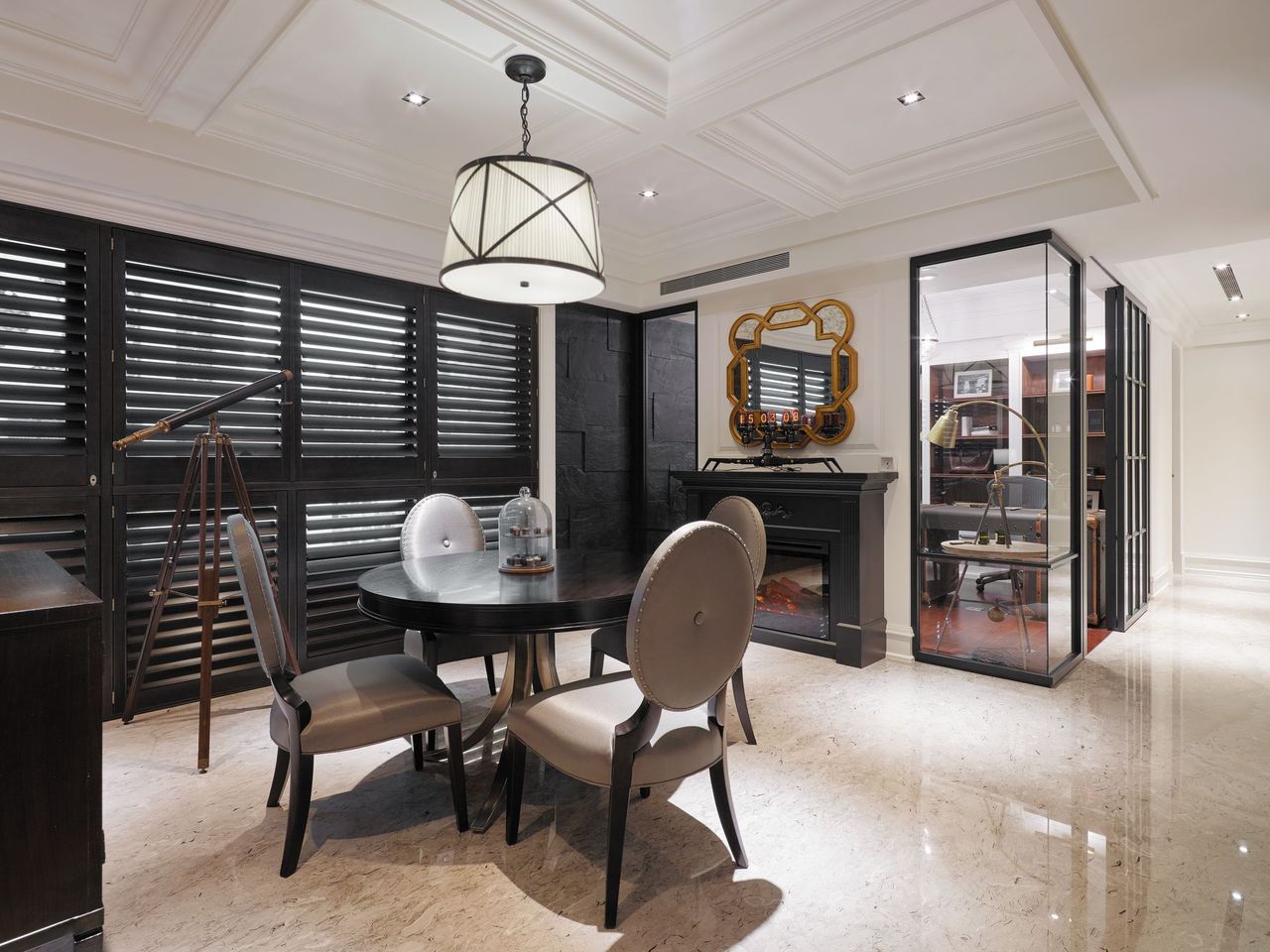 A round black table and chairs sit on a marble floor in a room featuring black shutters, a fireplace, and glass office.