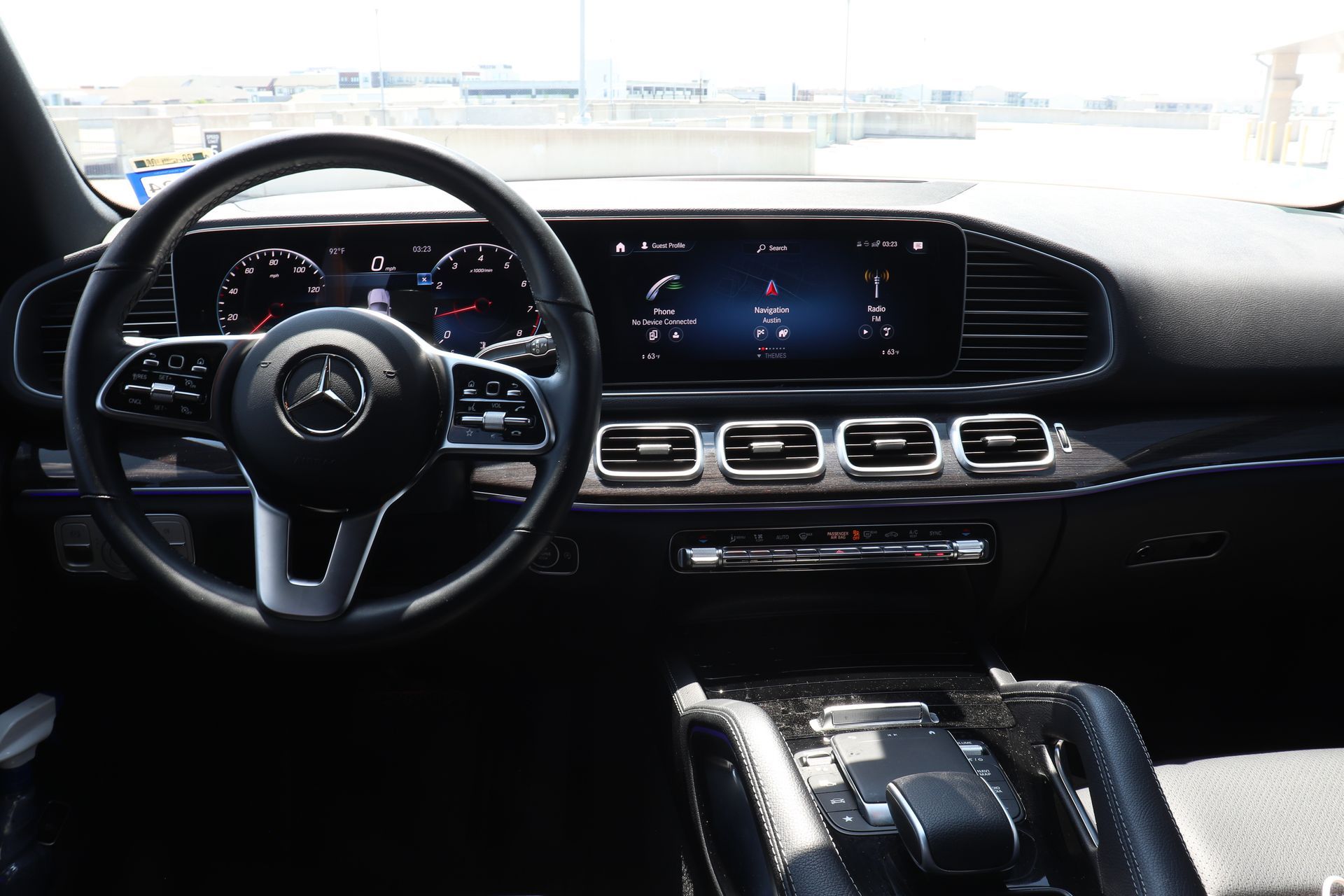 Interior of a Mercedes-Benz SUV, showing the dashboard with steering wheel, digital displays, and center console.