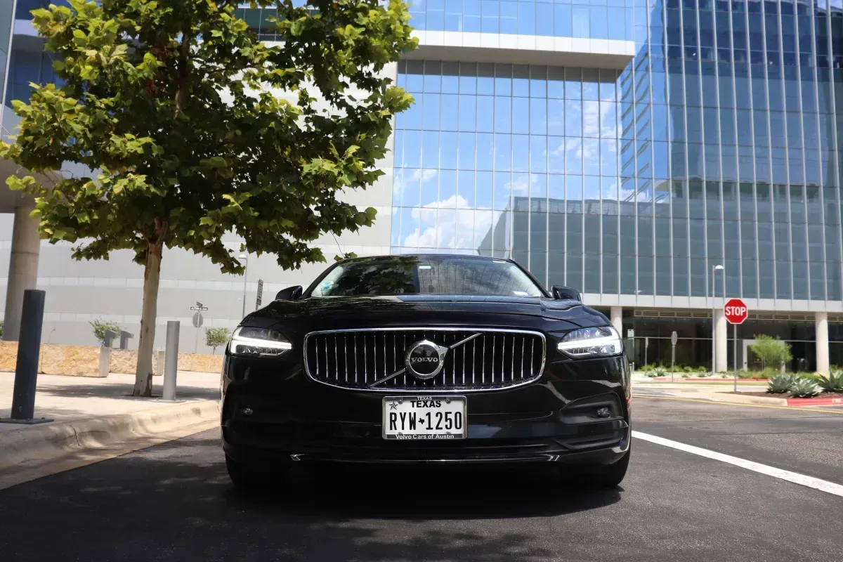 A black and white photo of a row of cars parked next to each other.