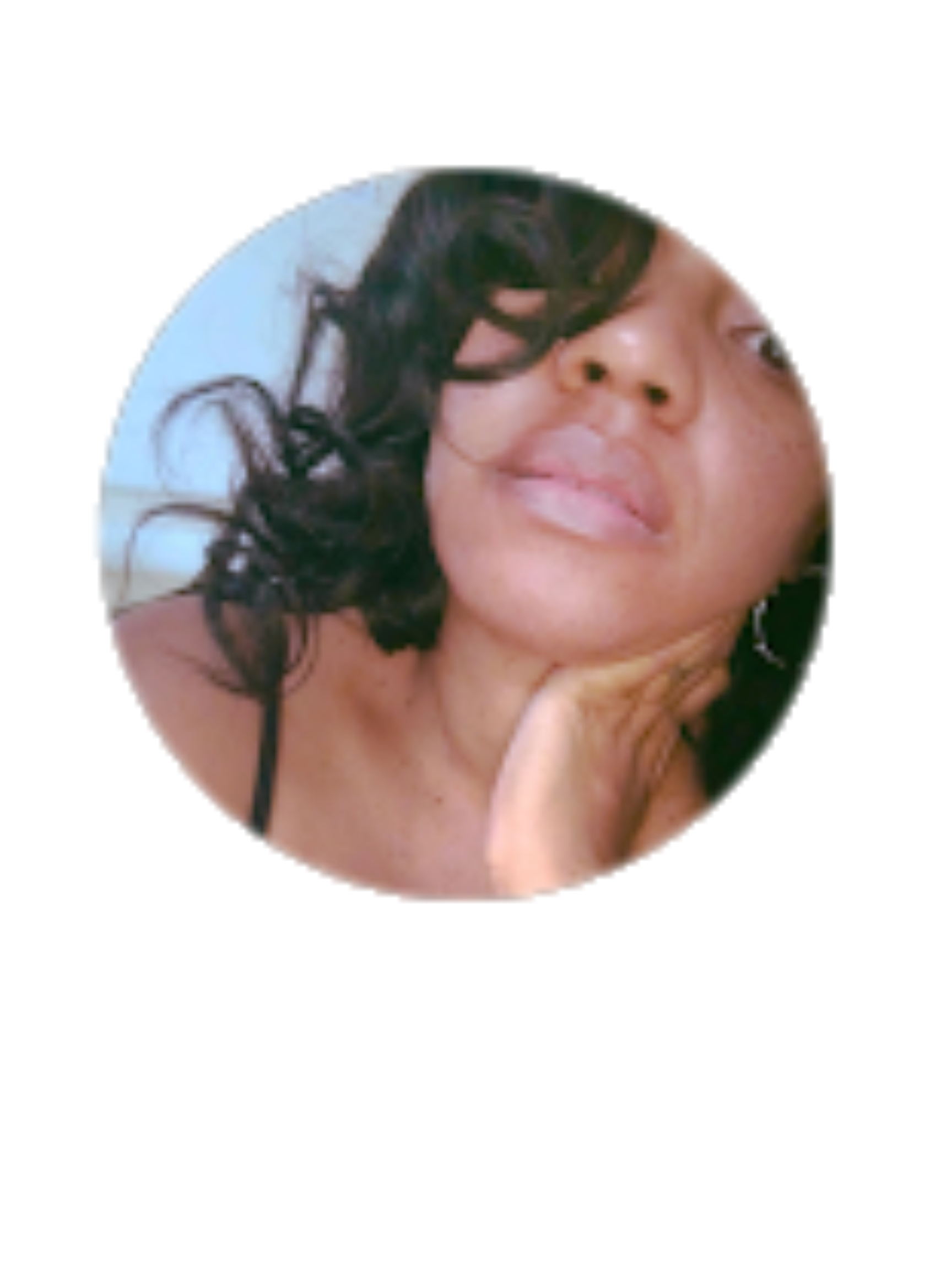 Woman with dark hair, resting chin on hand, looking at camera.