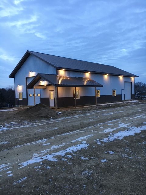 A blue house with a wooden porch and stairs
