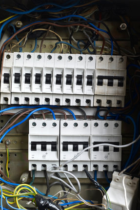 A bunch of electrical switches and wires in a box