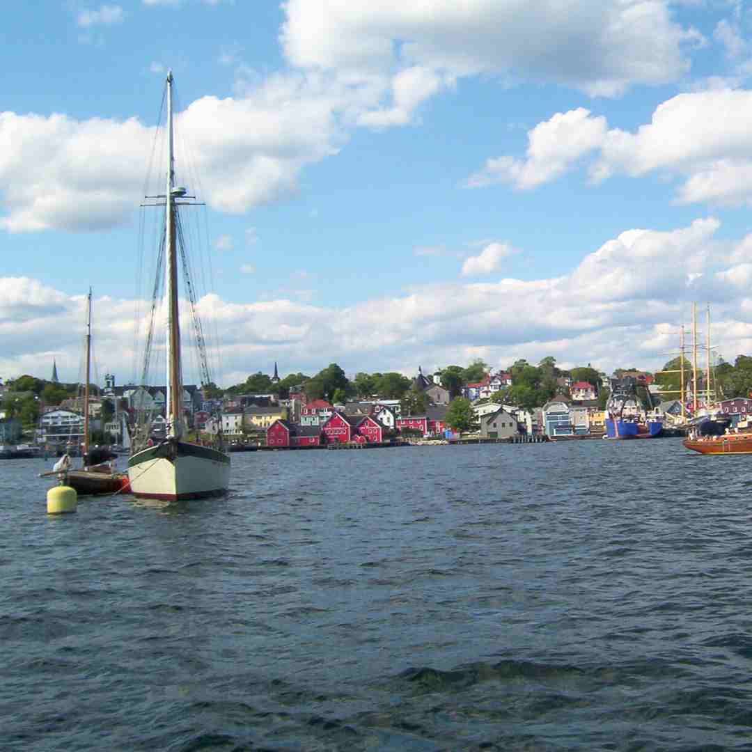 Baddeck, Nova Scotia. View from the water on the colorful small buildings and a few boats.