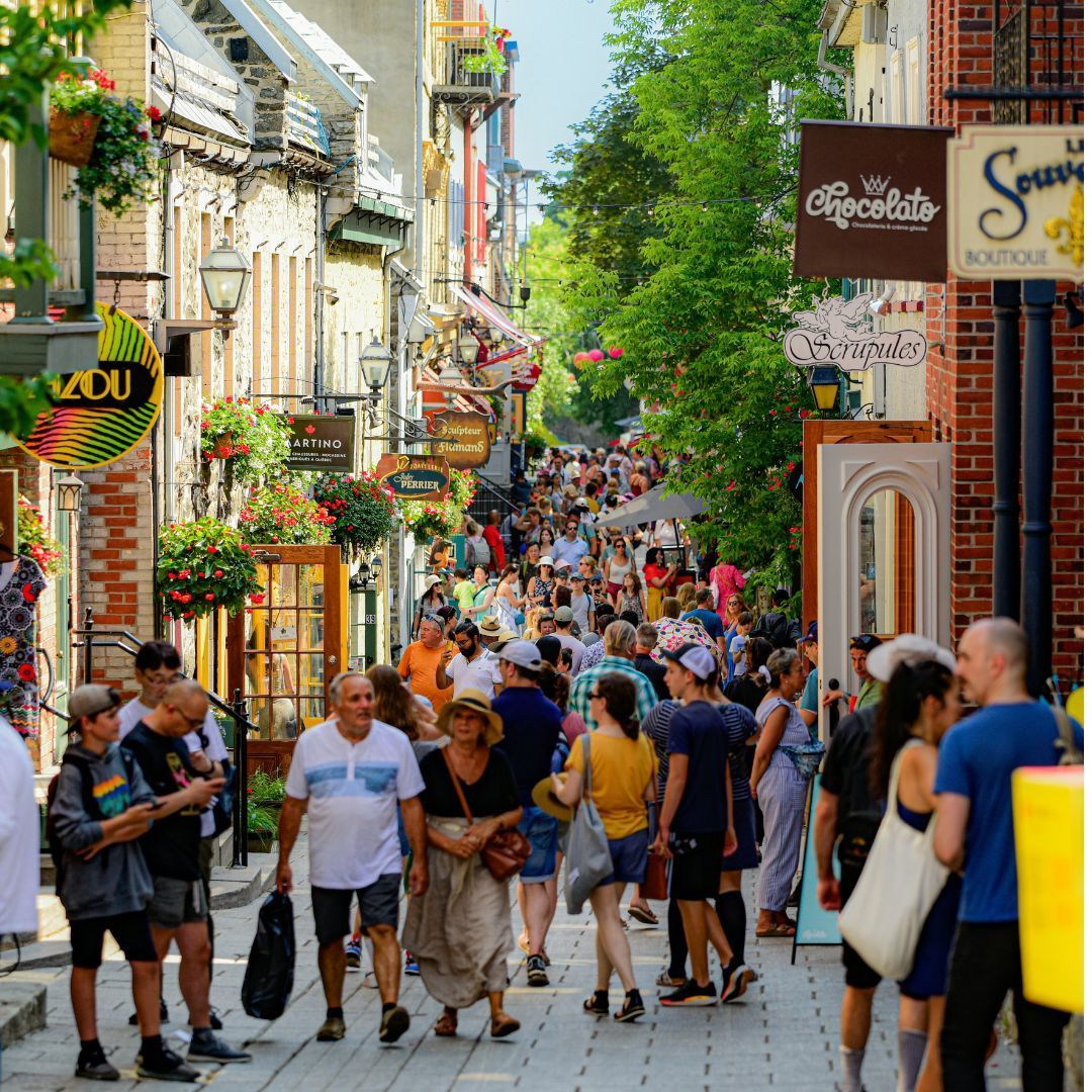 Bustling cobblestone street in Quebec City on a sunny summer day