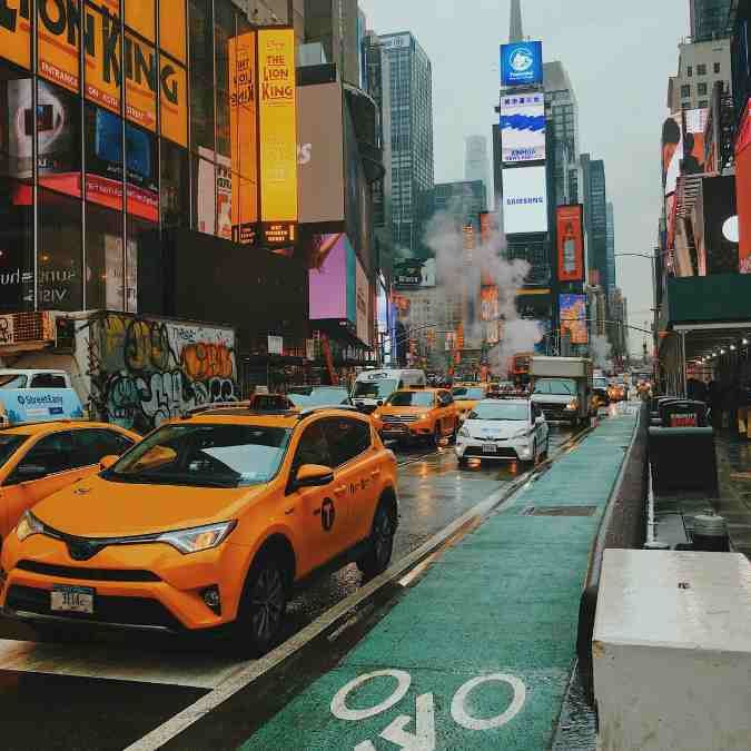 New York busy street with iconic yellow taxi 