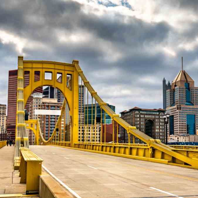 Iconic yellow bridge spanning the river in Pittsburgh