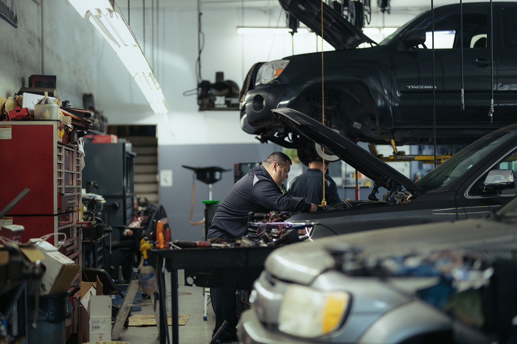 A man is working on a car in a garage | Larsen Automotive