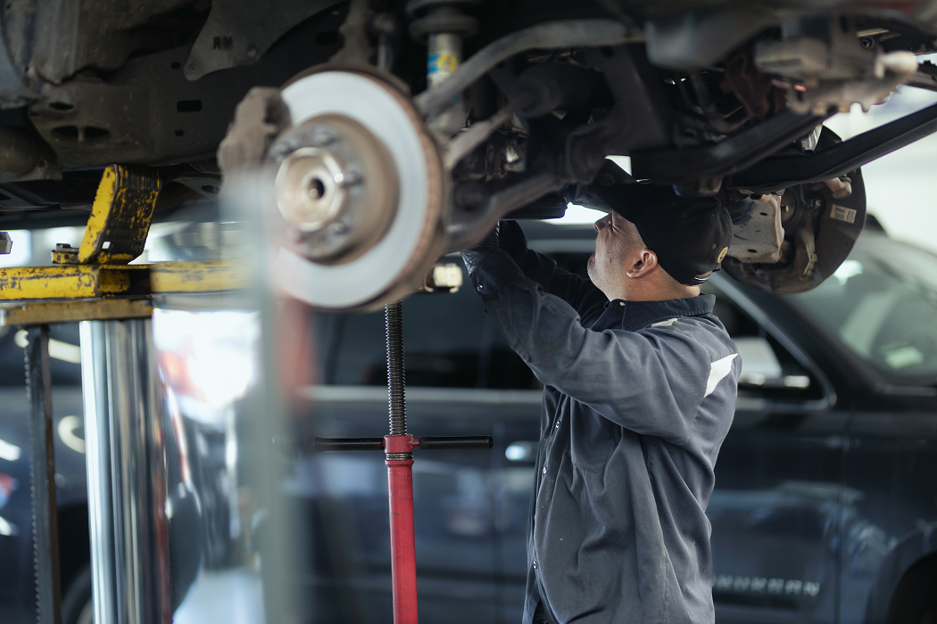 A man is working on a car in a garage | Larsen Automotive