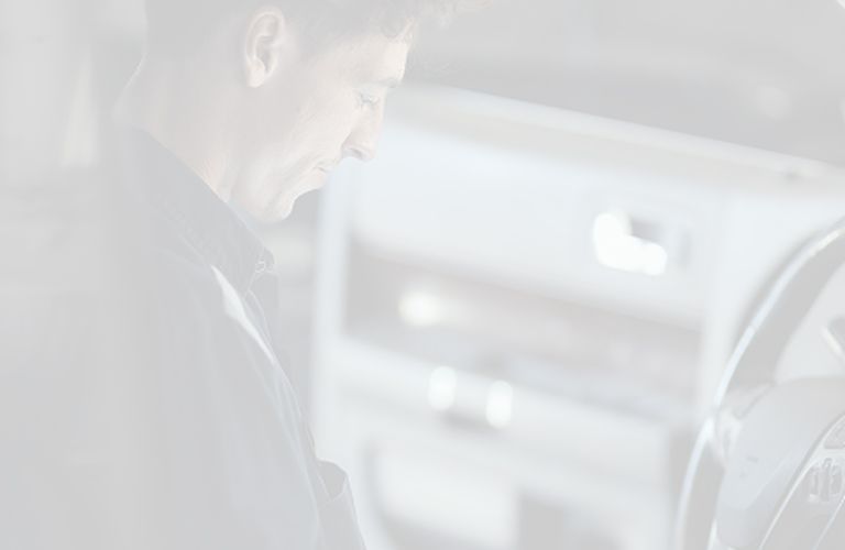 Staff helping customer at front desk | Larsen Automotive Inc