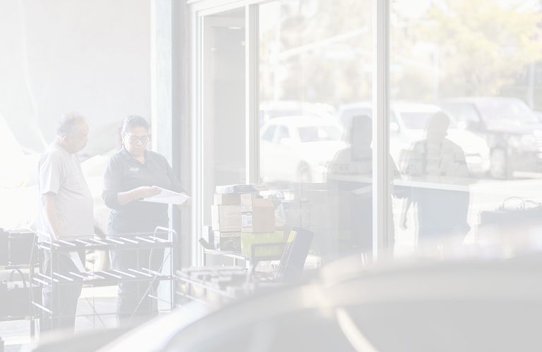 Staff helping customer at front desk | Larsen Automotive Inc